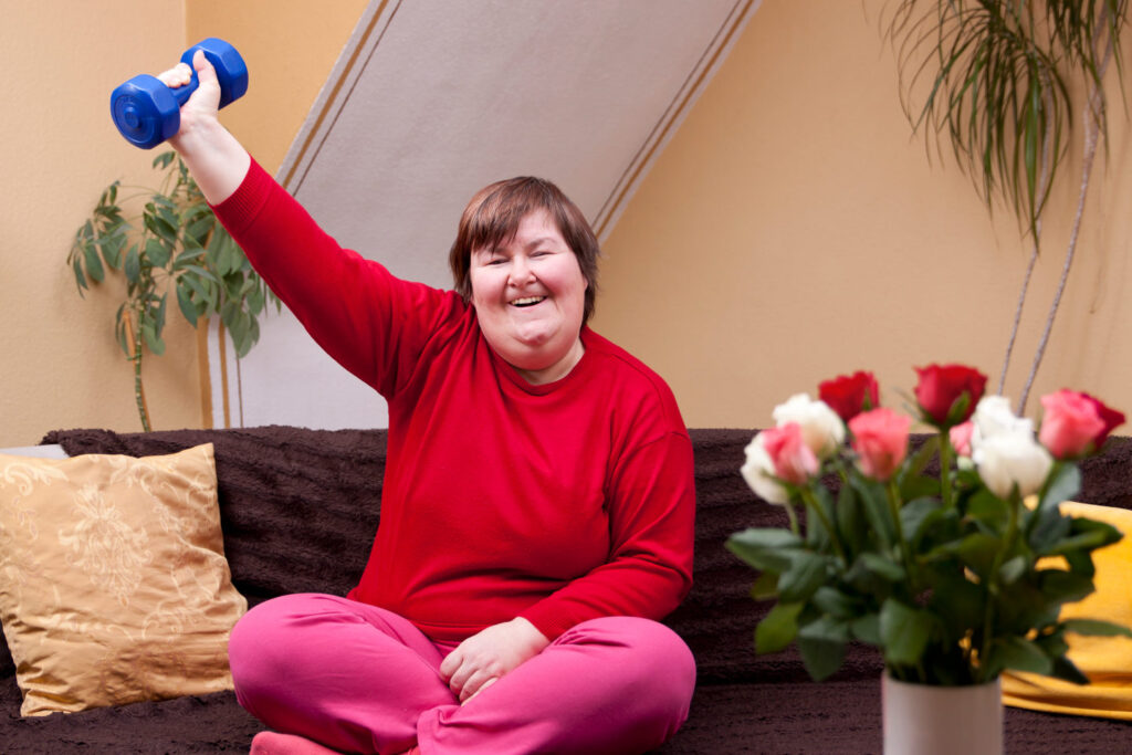 Mentally disabled woman shows her strength with a dumbbell